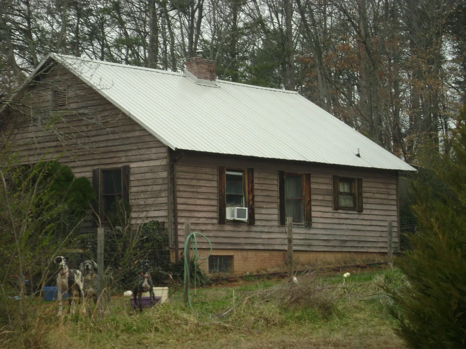 White metal roof on an old wood sided farmhouse, from a Metal Roof Installation job in Corry